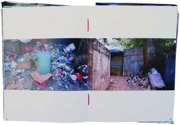 Book spread: a man sorting waste facing a passage of corrugated metal